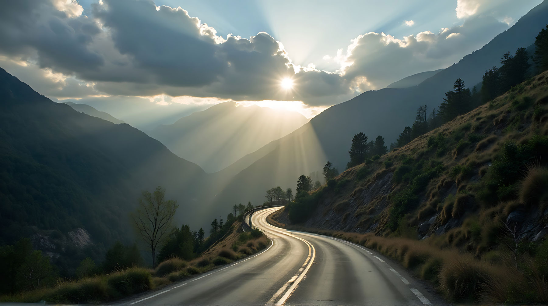 background image of sun peaking through clouds in a mountain landscape with a winding roadway